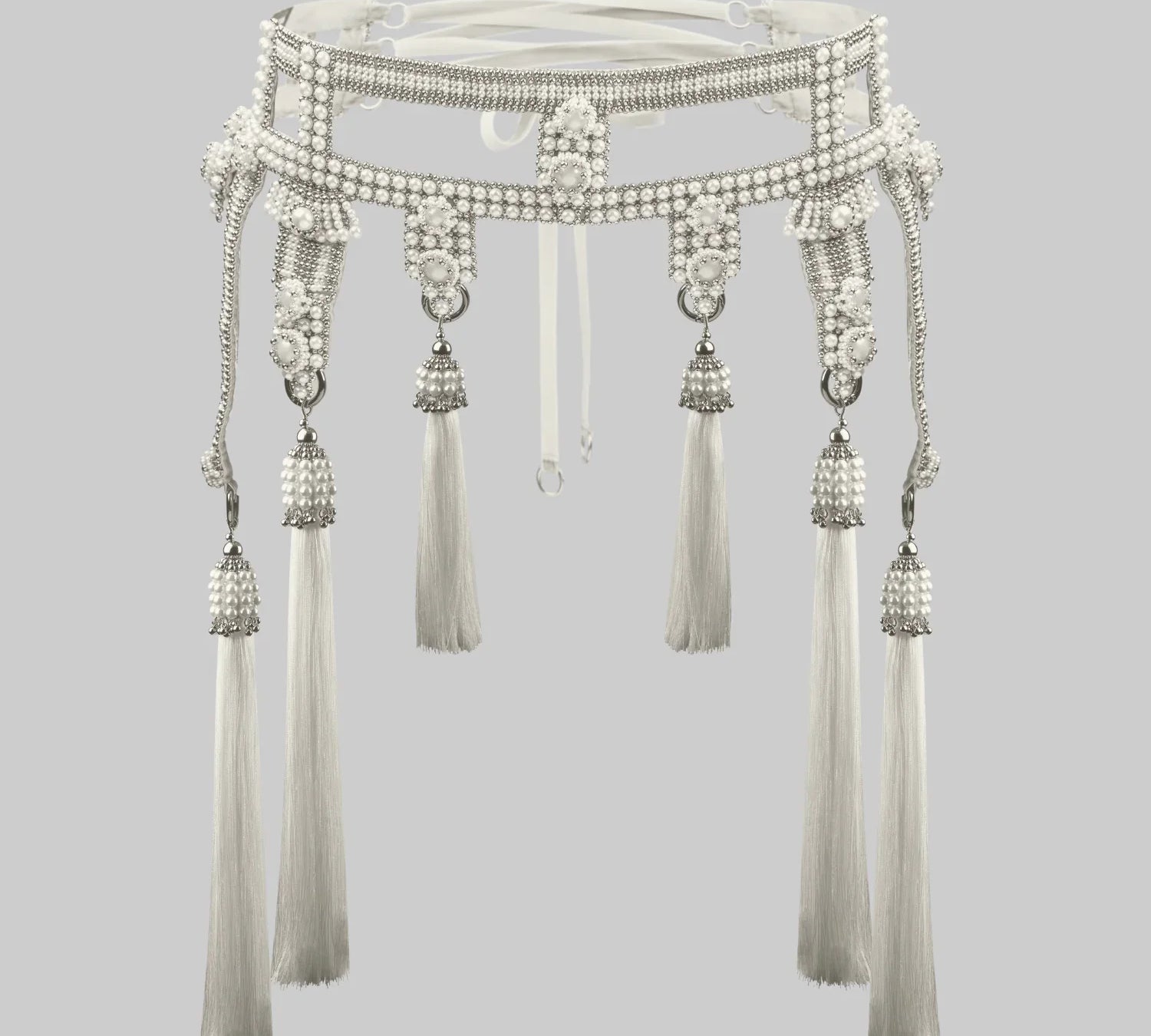 Decorative beaded belt made with synthetic pearls, and white thread tassels on a gray background
