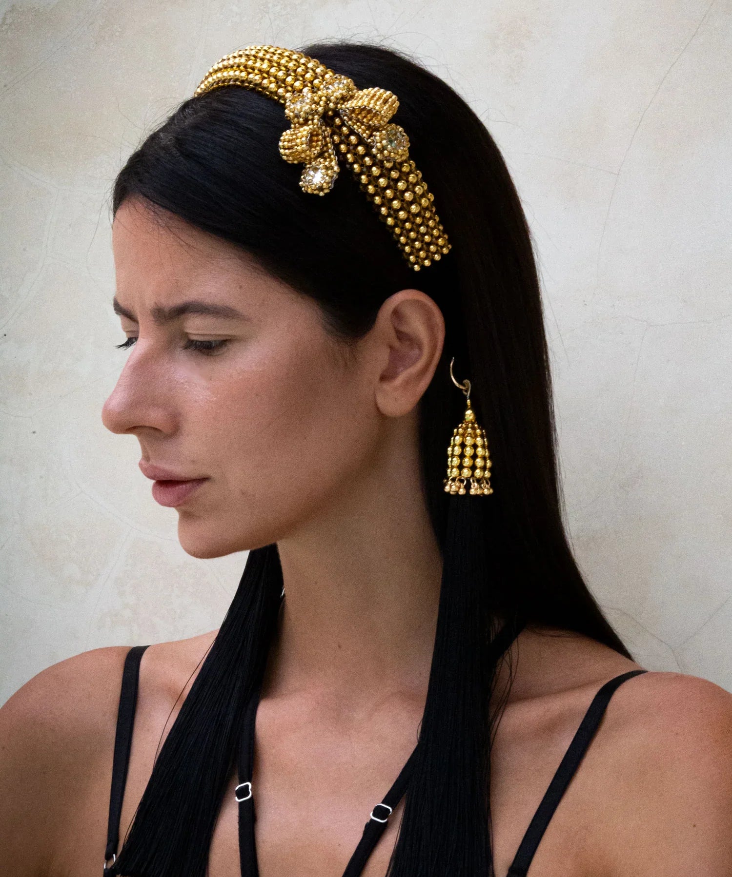 woman with Gold beaded Amaya Bow headband by Object & Dawn on a neutral background