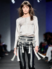 woman on stage using amaya modular belt in pearl using neutral top and leather long pants by object & dawn