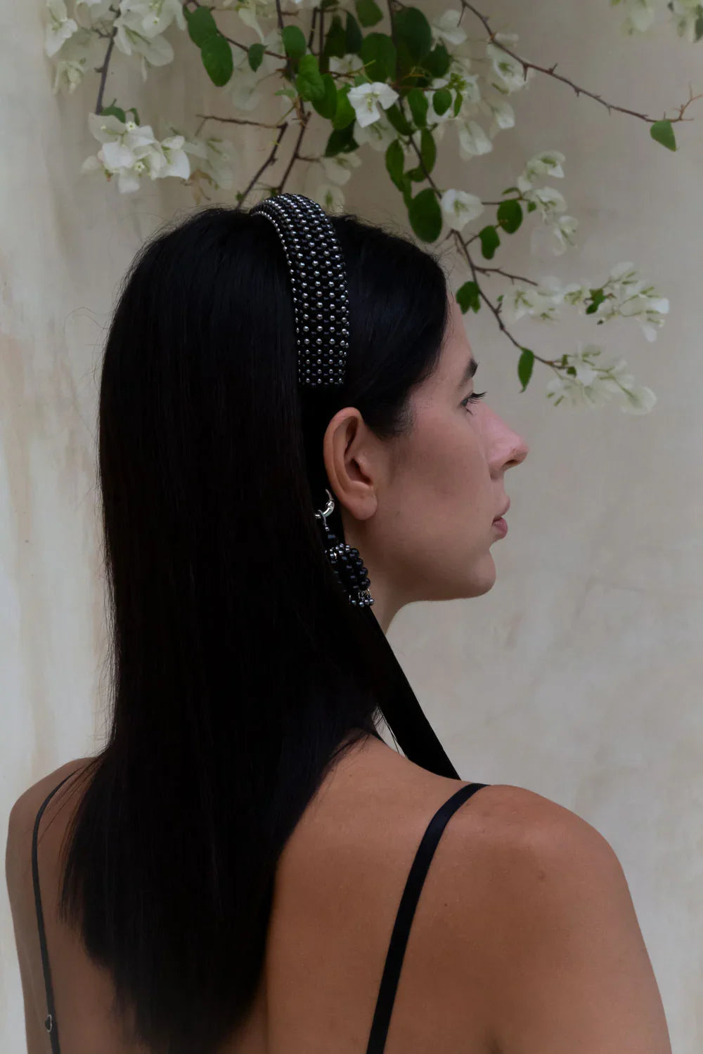 woman  with handcrafted Silver beaded  with black crystals amaya headband  by Object & Dawn worn by a person with a neutral background back view