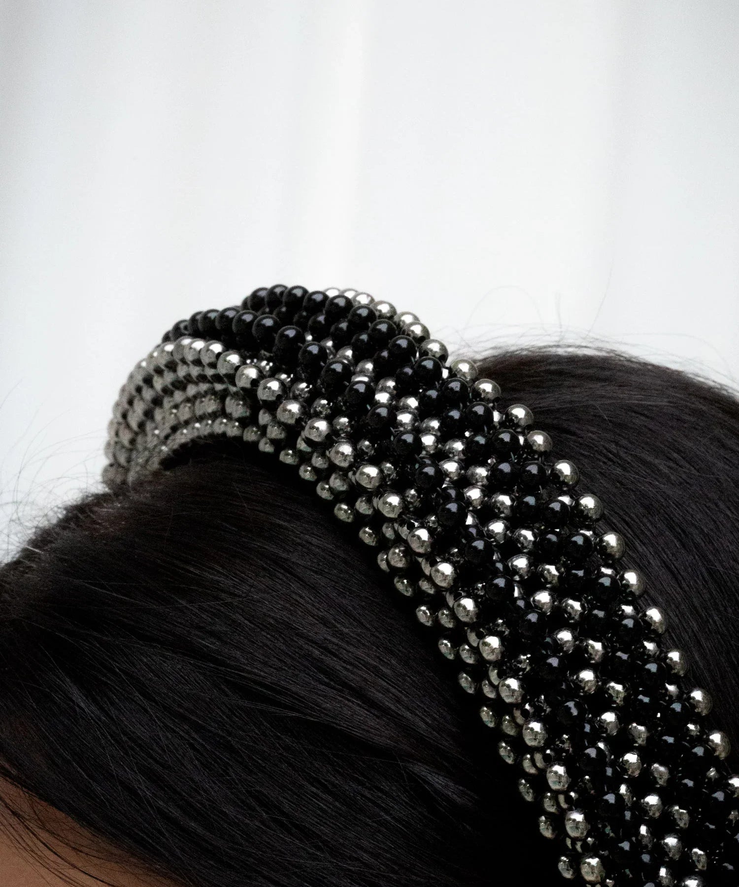 Object & Dawn Anais Headband jet black detail view worn by woman in neutral background