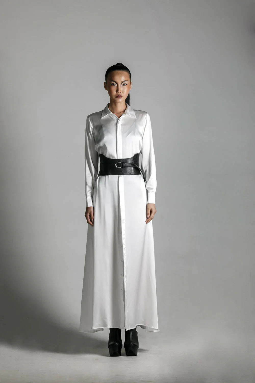 woman wears anais long sleeve silk shirt dress with corset belt by object & dawn in neutral background