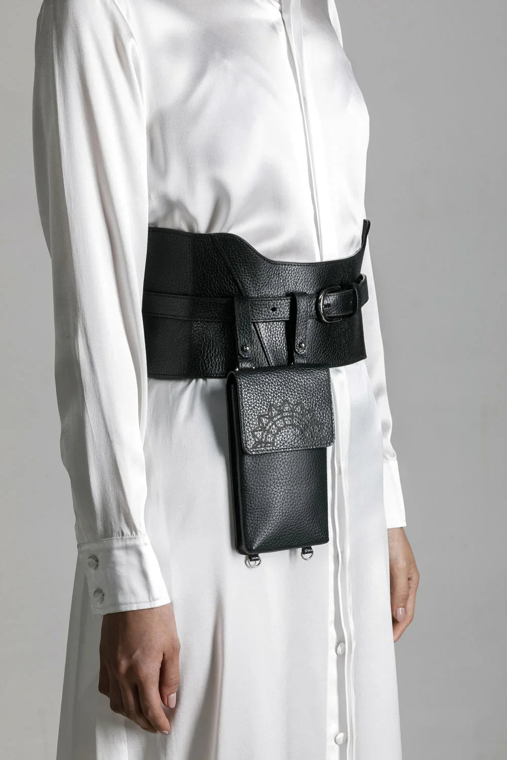 woman in white shirt dress wear zheng iphone bag and corset belt by object and dawn close up in netural background