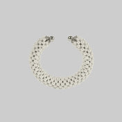 Handcrafted modular bracelet cuff from syntethic japanese pearl on neutral background up view
