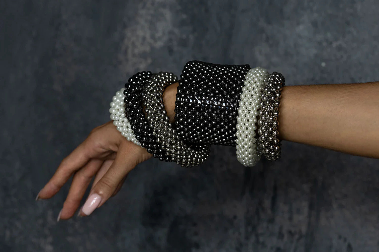 Object & Dawn beaded wrist accessory in ivory, structured supple cuff with polymer metal beads close up worn view