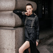 Woman wearing black beaded top with matching cuffs over silk shirt dress