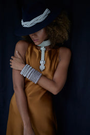 woman in brown outfit with blue background wear pearl bridal union beaded items by object and dawn