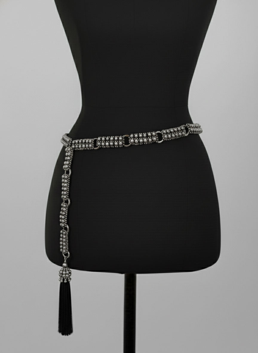 Beaded Adjustable Chain belt with tassels by Object & Dawn on a mannequin against a gray background