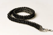 beaded modular hat band for hat accecories by object and dawn in white background close up logo view