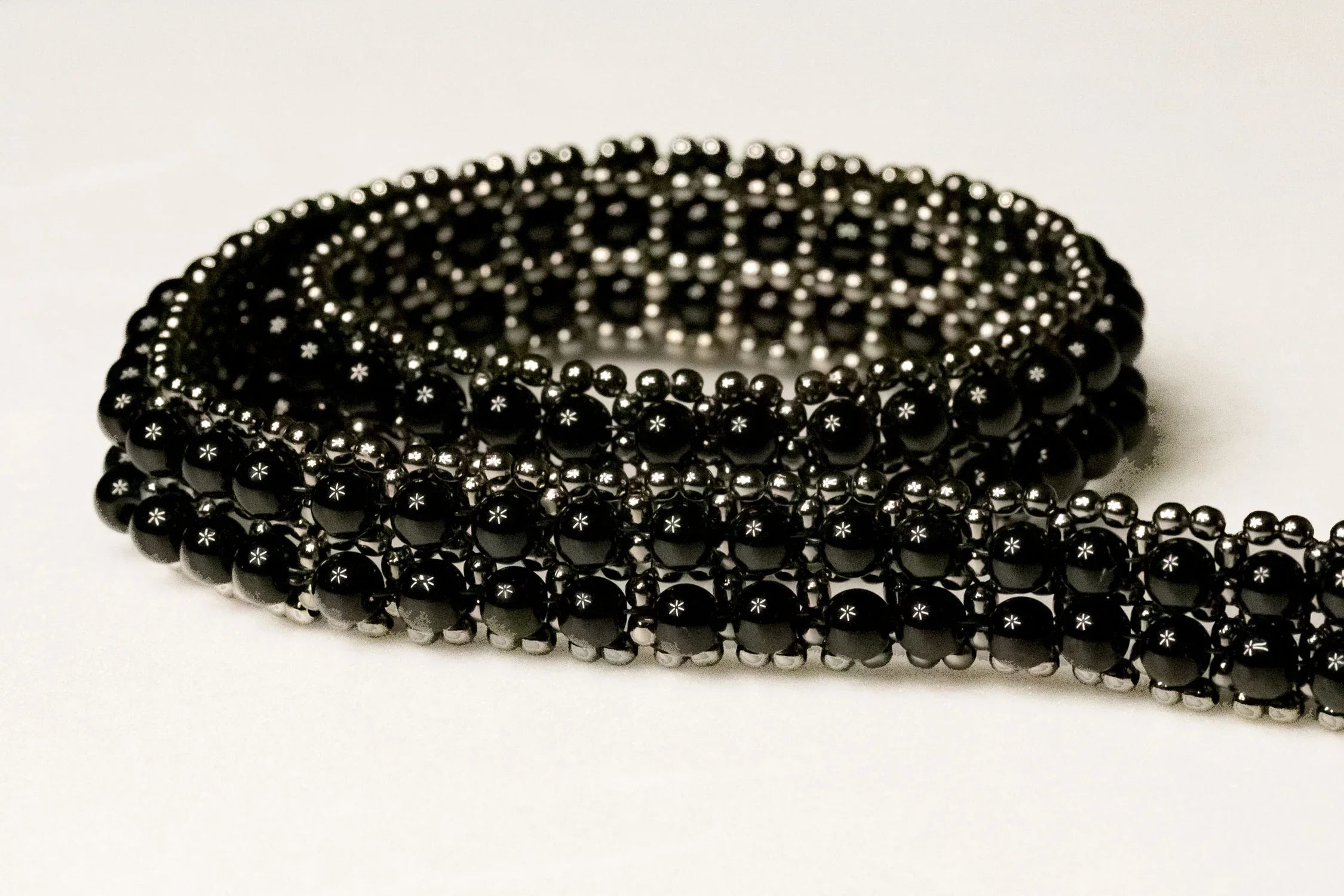 detail of beaded modular hat band for hat accecories by object and dawn in white background