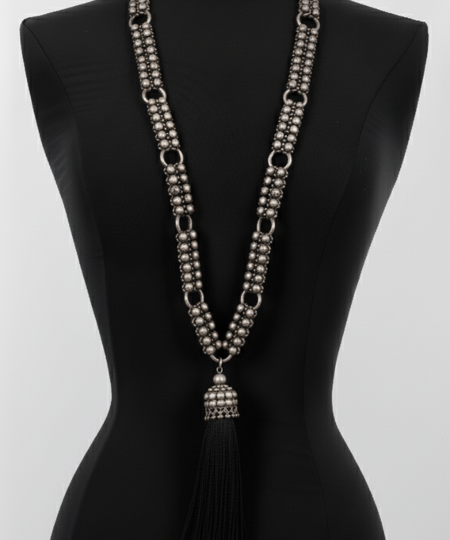Beaded Link Neklace with tassel  By Object & Dawn on a black mannequin against a white background