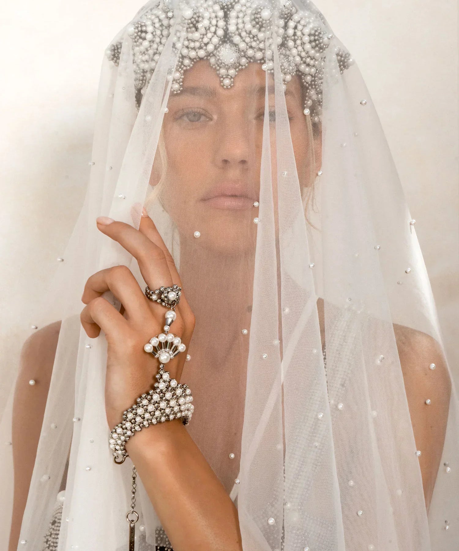 A blond bride is wearing a sheer veil over the Eingana Crown and pearl bracelet & ring combo by Object & Dawn. 