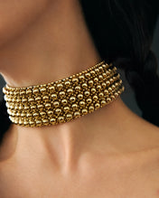 close up of celestial beaded choker gold by object and dawn side view