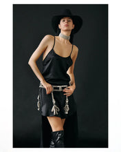 woman standing wearing black hat and black teuta dress celestial choker and teuta belt in silver by Object & Dawn on a black background