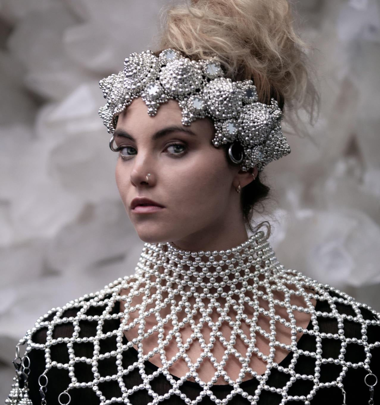 blond bride wearing chrome beaded crown and pearl beaded cape by Object & Dawn with blurred white background