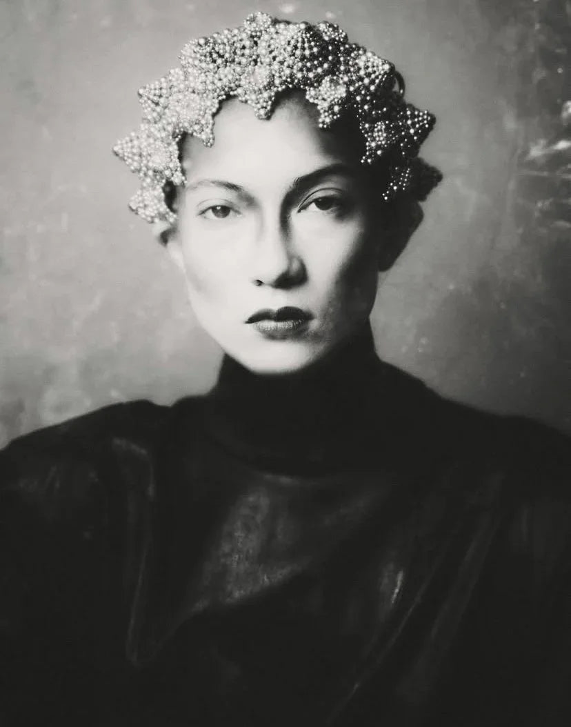 woman wears handcrafted modular crown by silver coated polymer beads by object and dawn in grey background front view