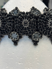 handcrafted modular crown with silver coated polymer beads and black crystal by object and dawn ghost image in white background close up view