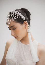 East asiaan bride wearing Freja Headband in Pearl with two white 11" tassels. 