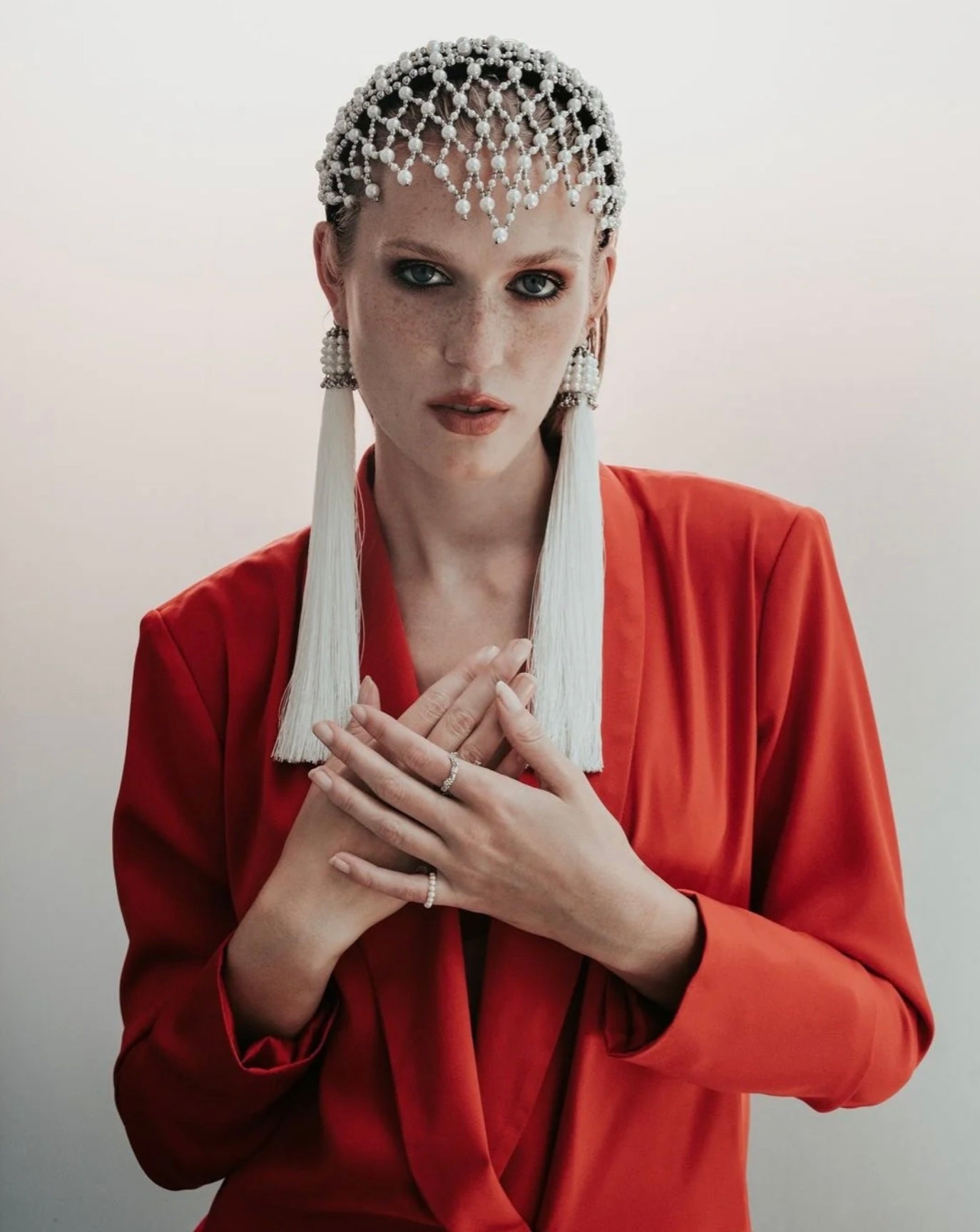 Woman in red outfit wear Freja Headband in Pearl by Object&Dawn