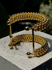 close-up of handcrafted beaded hera cuff with 22k gold wash beads 