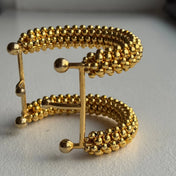 close-up of handcrafted beaded hera cuff with 22k gold wash beads 