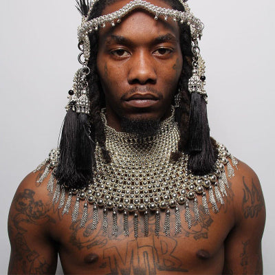 Offset wearing elaborate silver headpiece and necklace by Object &amp; dawn on a plain background