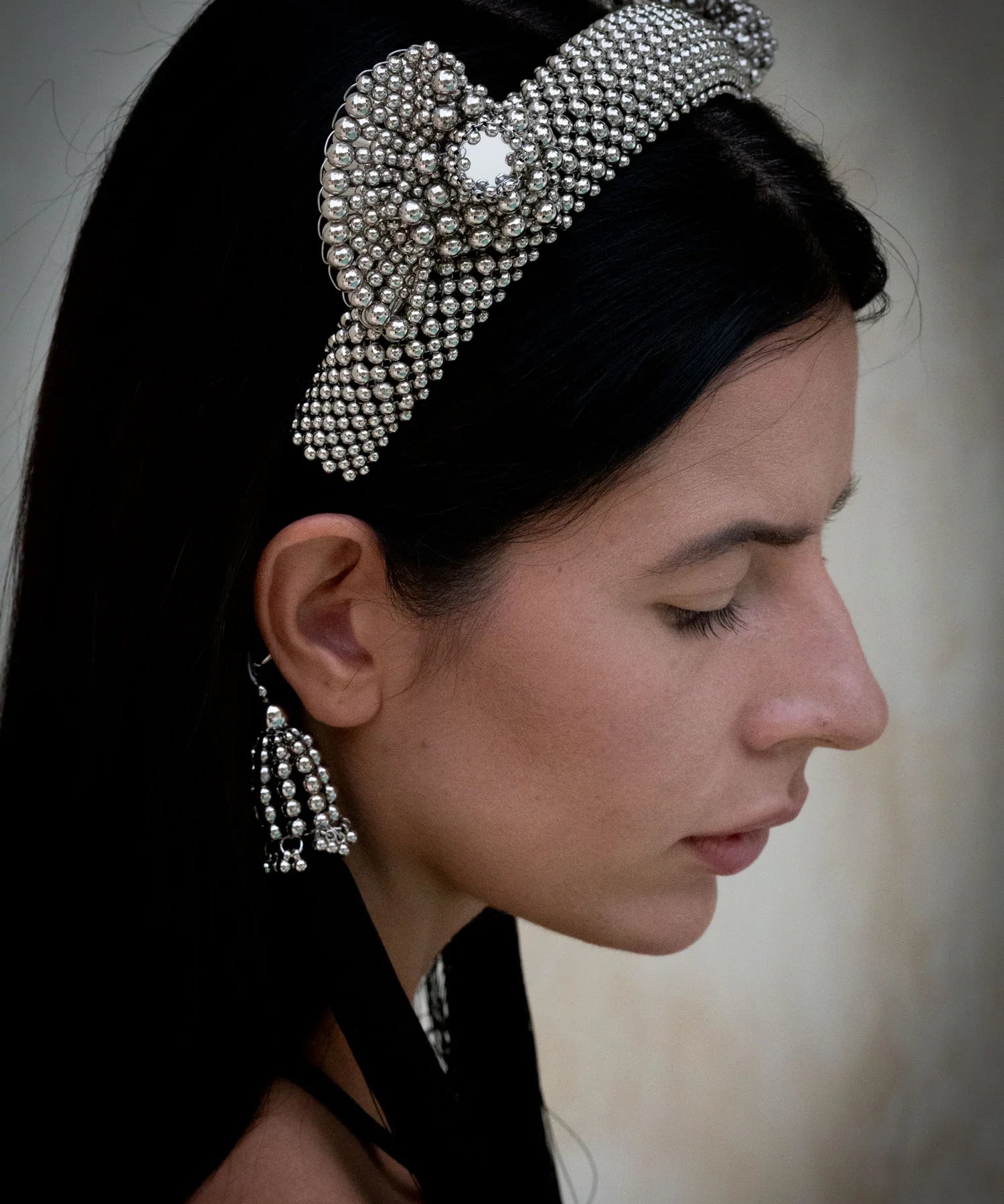 Object & Dawn Beaded Jas Headband silver with 11" taseels silver-black worn by woman in neutral background