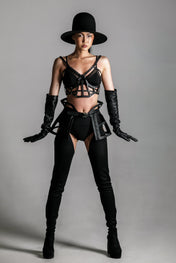 woman with premium leather studded cage top black on grey background
