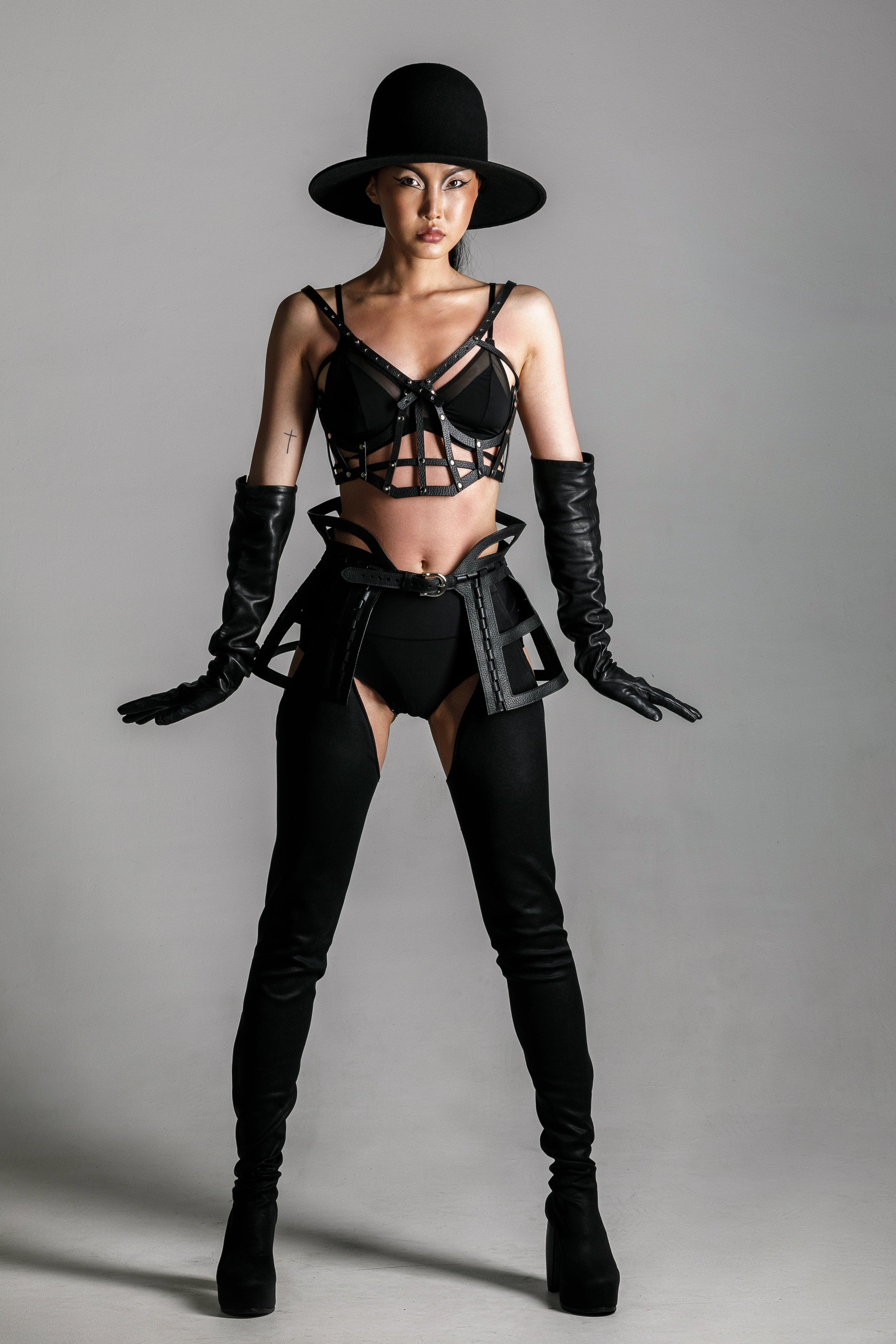 woman with premium leather studded cage top black on grey background