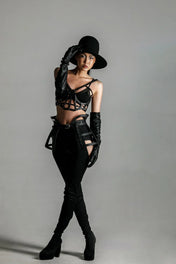woman with premium leather studded cage top black on grey background front view