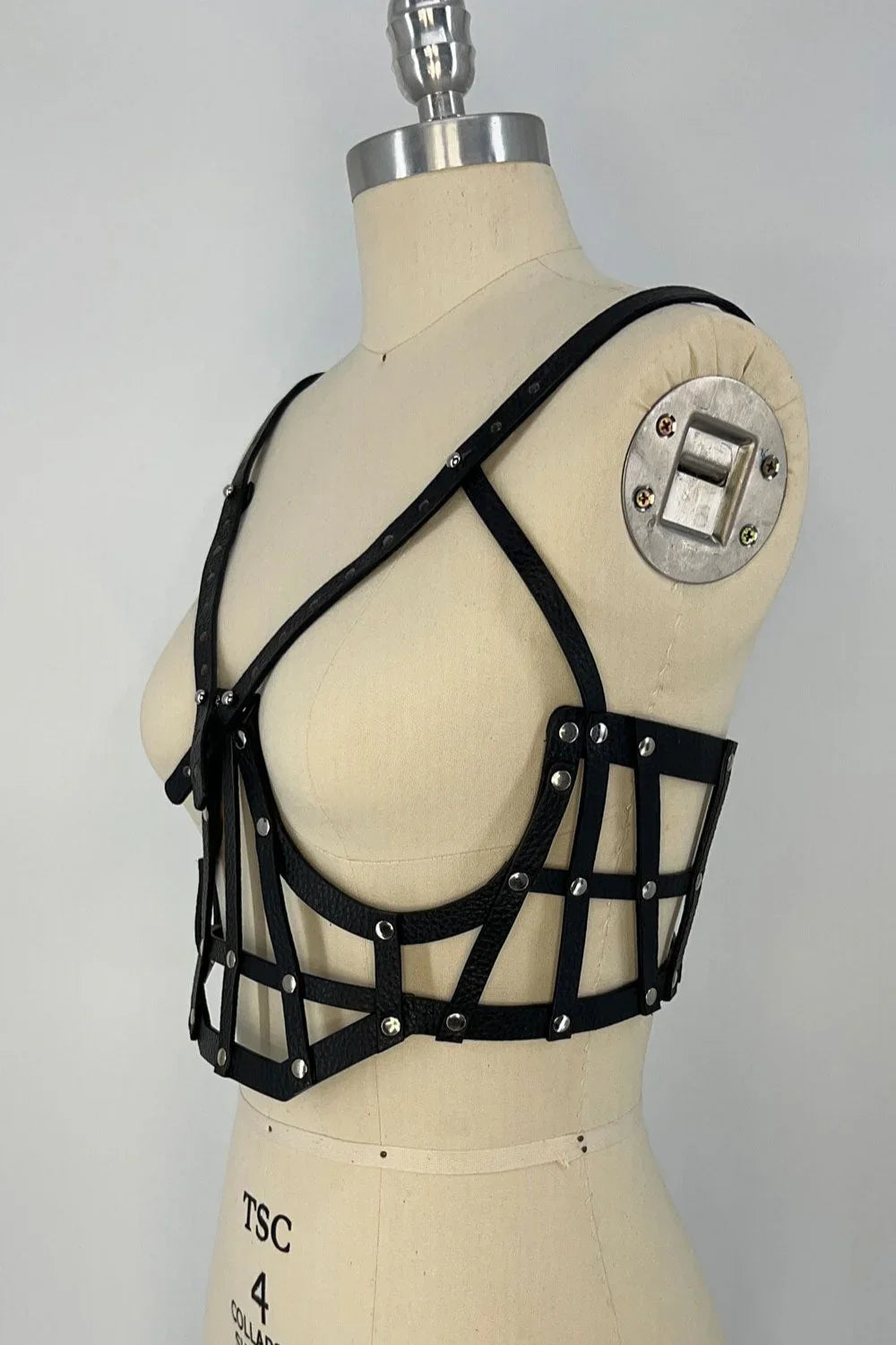 beaded premium leather Jas Studded Cage top by object and dawn on mannequin in white background diagonal side view 