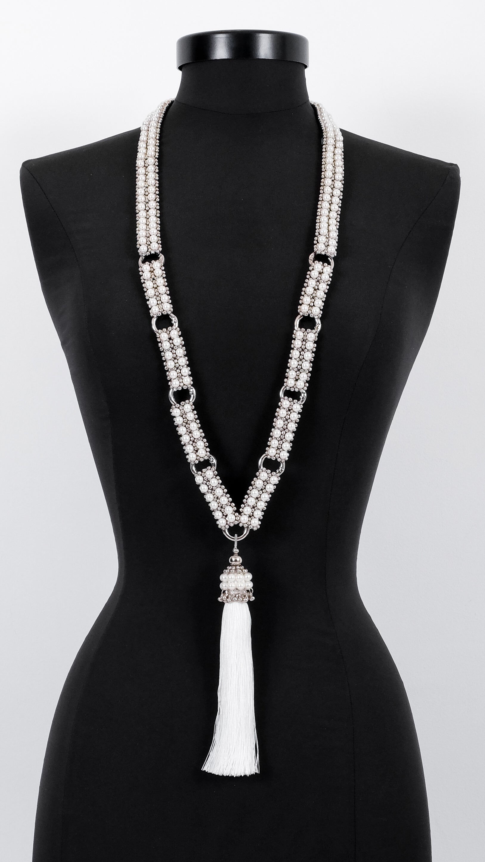 Adjustable Beaded Necklace by Object & Dawn tassel on a black mannequin against a white background