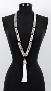 Adjustable Beaded Necklace by Object & Dawn tassel on a black mannequin against a white background