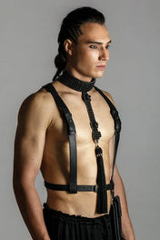 man wears elohim t-choker in jet black with leather harness black by object and dawn standing on grey background side view