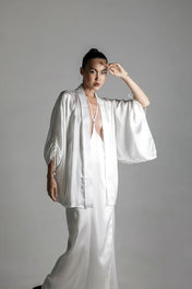 short white silk kimono with white harness skirt worn view up by object and dawn at neutral background