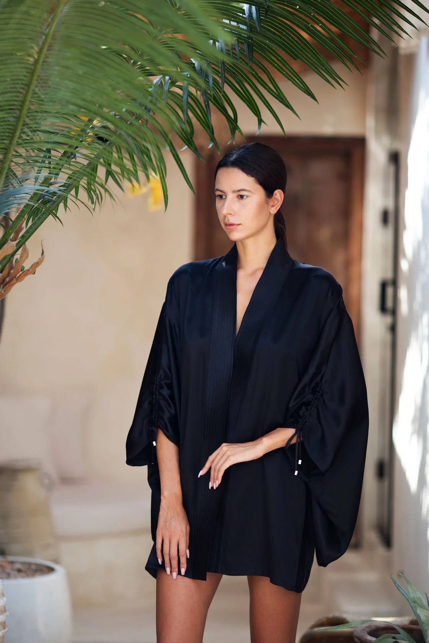 short black silk kimono worn view in close up by object and dawn at neutral background