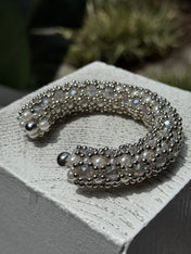 side shoot of handcrafted beaded cuffs with crystal and pearl embellishments in silver tone by object&dawn