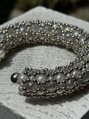 close-up of handcrafted beaded cuffs with crystal and pearl embellishments in silver tone by object&dawn