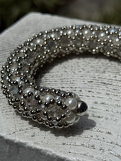 side close-up of handcrafted beaded cuffs with crystal and pearl embellishments in silver tone by object&dawn