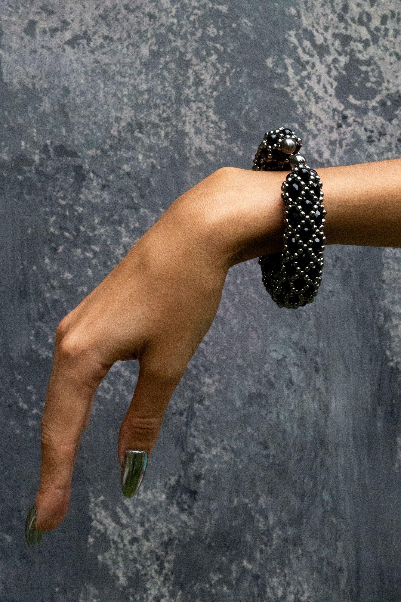 hand with handcrafted beaded nyx supple cuff in jetblack by object and dawn