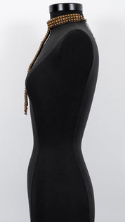 Signature Slim T-Choker Antq Gold on a mannequin against a white background by Object & Dawn.