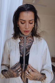 woman with tattoes in beidge outfit wear t shape choker harness antique silver by object and dawn 