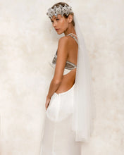 eingana modular crown with white harness skirt worn on woman by object and dawn at neutral background side view