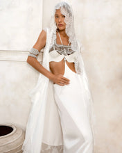woman wear bride oufit in white robe lace with handcrafted modular beads crown and harness in pearl by object and dawn