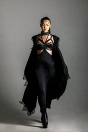 woman with harness skirt and teuta lace robe by object and dawn