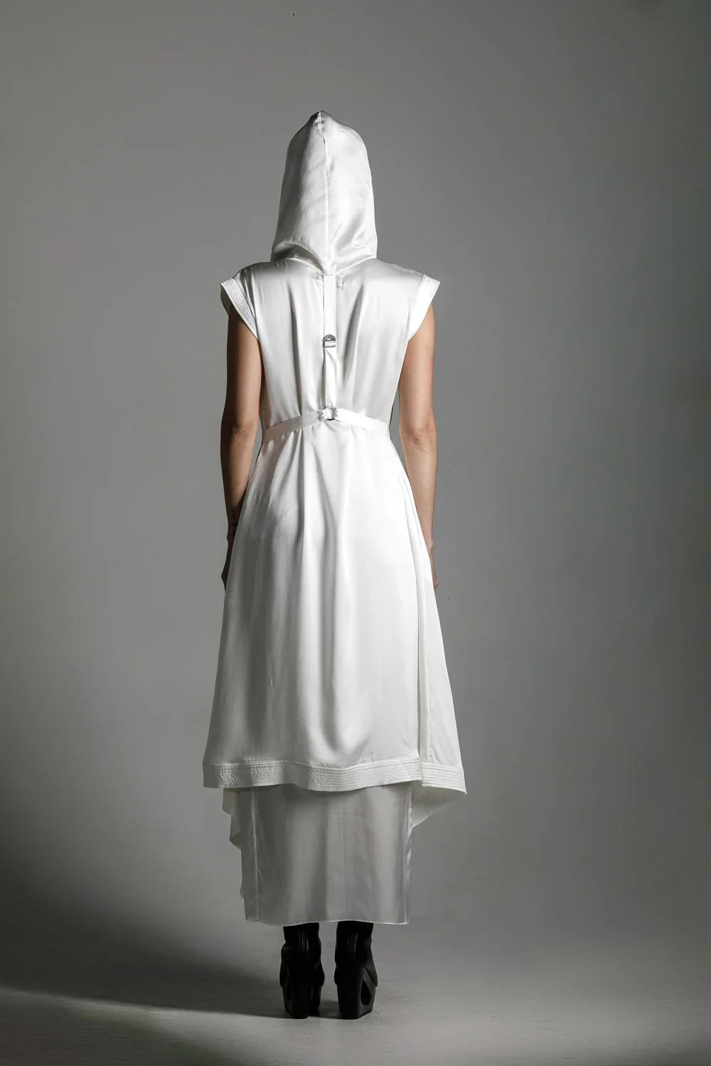 back view of woman with luxury silk top stiched hooded cap in white by object and dawn