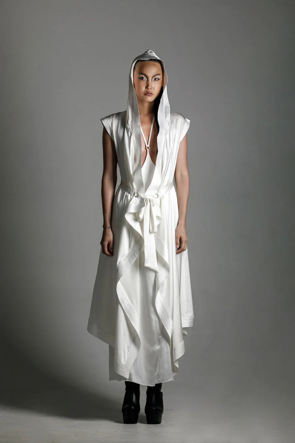 woman with luxury silk top stiched hooded cap and tamoe harness skirt in white by object and dawn