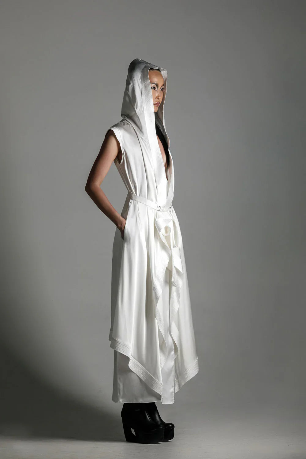 woman with luxury silk top stiched hooded cap and tamoe silk harness skirt in white by object and dawn