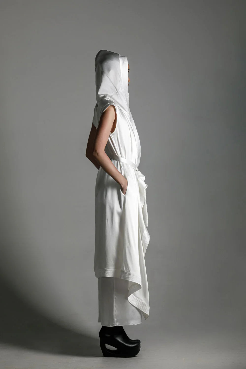 side view of woman with luxury silk top stiched hooded cap in white by object and dawn
