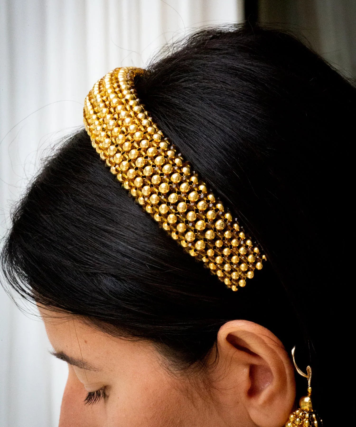 Gold beaded Teuta headband worn by a person with a neutral background by Object & Dawn